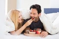 Couple eating breakfast on bed Royalty Free Stock Photo