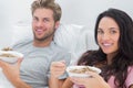 Couple eating cereal for breakfast Royalty Free Stock Photo