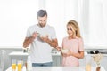 Couple eating cereal during breakfast at kitchen