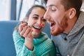 Couple eating a dessert spoon in cafe on date