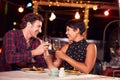 Couple eating dinner at rooftop restuarant