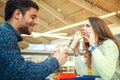 Couple eating in fast food restaurant Royalty Free Stock Photo