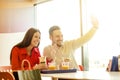 Couple eating in fast food restaurant Royalty Free Stock Photo