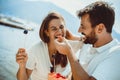 Couple eating fruit on the beach- summer party with friends and healthy food concept Royalty Free Stock Photo