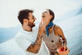 Couple eating fruit on the beach- summer party with friends and healthy food concept Royalty Free Stock Photo