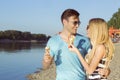 Couple eating ice cream and having fun at the beach