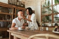 Couple Eating At Kitchen Table. Woman Feeding Vegetarian Food To Man. Family Lunch In Villa At Tropical Resort. Royalty Free Stock Photo