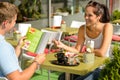 Couple eating looking at menu cafe restaurant