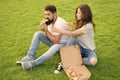 Couple eating pizza relaxing on green lawn. Fast food delivery. Bearded man and woman enjoy cheesy pizza. Couple in love Royalty Free Stock Photo
