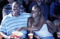 Couple Eating Popcorn While Watching Movie In Theatre Royalty Free Stock Photo