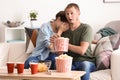 Couple eating popcorn while watching soap opera at home Royalty Free Stock Photo