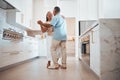 Couple, elderly and dance in kitchen for love, romance and happy together while home in retirement. Senior, man and Royalty Free Stock Photo