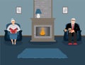 A couple of elderly people are sitting by the fireplace in a beautiful cozy blue living room Royalty Free Stock Photo