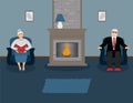 A couple of elderly people are sitting by the fireplace in a beautiful cozy blue living room Royalty Free Stock Photo