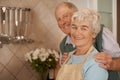 Couple, elderly and portrait with smile in kitchen for love, bonding and cooking together in home for anniversary. Happy Royalty Free Stock Photo