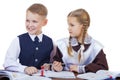A couple of elementary school students sit at a desk
