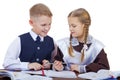 A couple of elementary school students sit at a desk