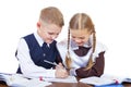 A couple of elementary school students sit at a desk