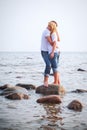 Couple embrace on a stone in sea