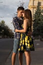 couple embracing against the background of the city, the road. urban romance.man stretches to the lips of a girl, wants to kiss he Royalty Free Stock Photo