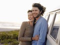 Couple Embracing By Campervan On Beach