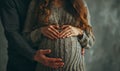 a couple embracing and forming heart shapes with their hands on the stomach of a pregnant woman Royalty Free Stock Photo