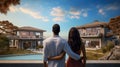 couple embracing in front of new big modern house, outdoor rear view back looking at their dream home Royalty Free Stock Photo