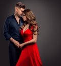 Couple Embracing in Love. Sexy Woman and Handsome Man in Romantic Hug over Gray. Lady in Red Dress with Boyfriend Royalty Free Stock Photo