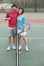 Couple embracing next to the tennis net Royalty Free Stock Photo