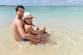 Couple embracing sitting in crystal clear seawater Royalty Free Stock Photo