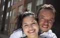 Couple embracing and smiling in front of their new first home. Royalty Free Stock Photo