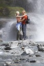 Couple Embracing Under Spray Of Waterfall Royalty Free Stock Photo