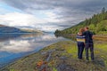 Couple enjoing the view at picnic area at Loch Linnhe - west coast Scotland