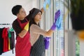 Couple enjoy houseworking and window cleaning together