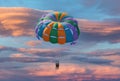 Couple enjoy parasailing flight during sunset