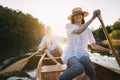 Smiling copuple paddling canoe on lake