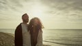 Couple enjoy sunset beach on nature sea landscape. Two people walking outside. Royalty Free Stock Photo