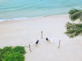 A couple enjoying a beach vacation at a tropical resort with a beautifully landscaped coastal pool at sunset. honeymoon