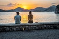 Couple enjoying beatiful sunset, romantic time of sunset in Montenegro