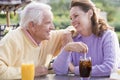 Couple Enjoying A Beverage By A Golf Course Royalty Free Stock Photo