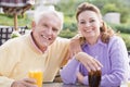 Couple Enjoying A Beverage By A Golf Course Royalty Free Stock Photo