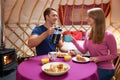 Couple Enjoying Breakfast Whilst Camping In Traditional Yurt Royalty Free Stock Photo