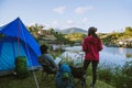 Couple Enjoying Camping Holiday In Countryside.Camp in the mountains near of the lake Royalty Free Stock Photo