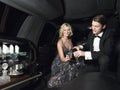 Couple Enjoying Champagne In Limousine