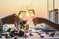 Couple enjoying of Cheers glass of wine in a restaurant at sunset.