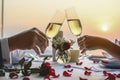 Couple enjoying of Cheers glass of wine in a restaurant at sunset.