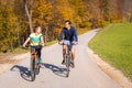 Couple enjoying cycling in the countryside during fall weekend trip