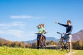 Couple enjoying cycling in the countryside during fall weekend trip