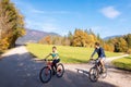 Couple enjoying cycling in the countryside during fall weekend trip