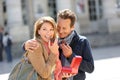 Couple enjoying eating pastries in town